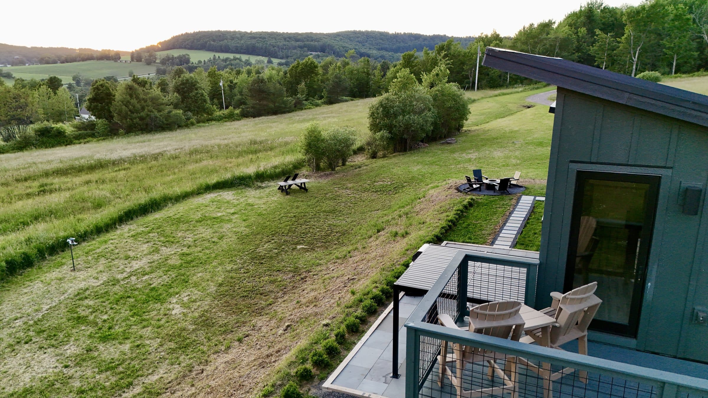The house and field from the air in the evening light